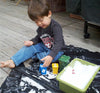 child playing with tub of snow