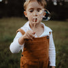 child blowing bubbles with bee wand