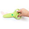 green scissors shown in hand