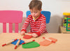 Boy rolling playdough with patterned rolling pin
