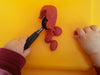 child's hands shown with tool