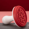 red snowflake design stamp with handle.