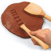 2 wooden tools shown with clay