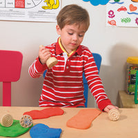 boy playing with stamper and dough