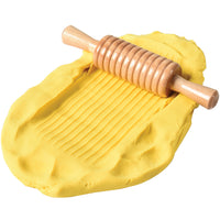 ridged rolling pin with yellow dough