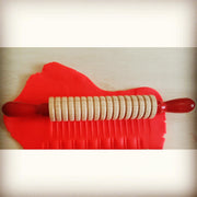 textured rolling pin with red handles