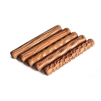 5 wooden rolling pins with patterns carved into them