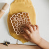 child's hand with honeycomb cutter