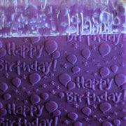 Clear rolling pin engraved with "Happy Birthday" and balloons