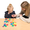 mother and daughter play with rainbow pebbles