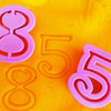 numbers 8 and 5 stamped into playdough