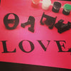 "L O V E" spelt on a t-shirt with fabric stamps
