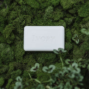 bar of white soap on green background