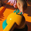 child playing with playdough extruded from lemon juicer
