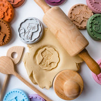 stamps, rolling pin and dough