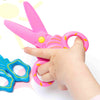 pink scissors shown in hand