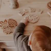 child playing with playdough and cutters