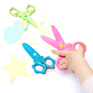 child's hands shown with pink scissors. Blue and green scissors also shown