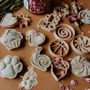 cutters with dough and petals
