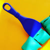 blue slicer shown in green playdough on a yellow table