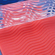 rolling pin shown with wavy line patterns in playdough
